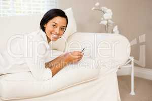 Smiling brunette using smartphone