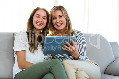 Mother and daughter use tablet