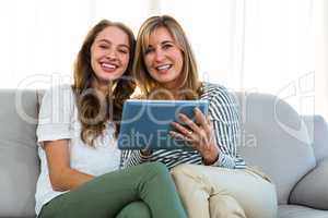 Mother and daughter use tablet