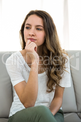 Woman thinking with hand on chin