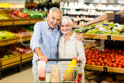 Portrsit of happy senior couple with cart Portrsit of happy senior couple with cart