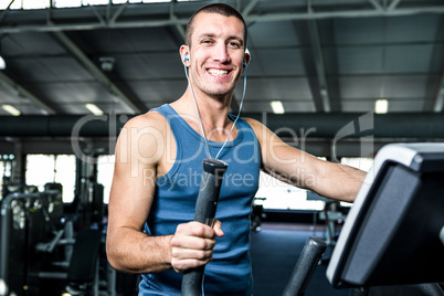 Smiling man working out with headphones on