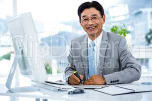 Portrait of happy businessman working