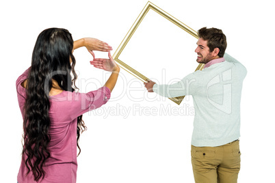 Happy couple holding picture frame