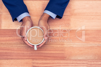 High angle view of business man holding coffee cup