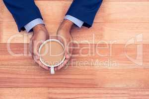 High angle view of business man holding coffee cup