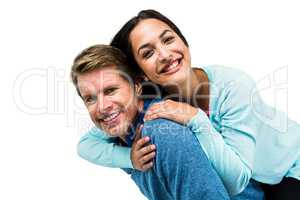 Cheerful man carrying girlfriend on back