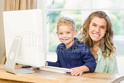 Mother and son using the computer