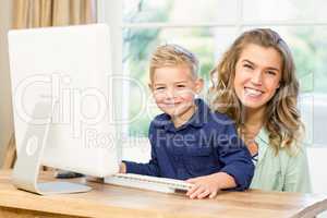 Mother and son using the computer