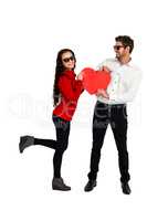 Smiling couple with sunglasses holding paper heart
