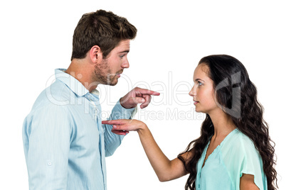 Couple pointing each other having argument