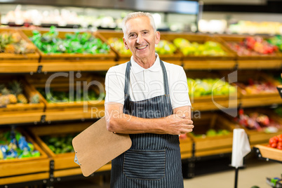 Mature worker with arms crossed and clipboard