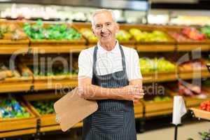 Mature worker with arms crossed and clipboard