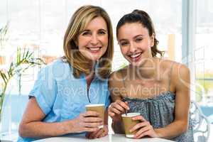 Mother and daughter drink tea