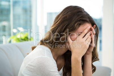 Sad woman on sofa