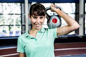 Portrait of woman holding kettlebell