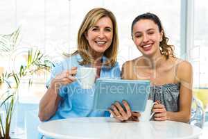 Mother and daughter watch tablet