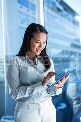 Smiling businesswoman using tablet