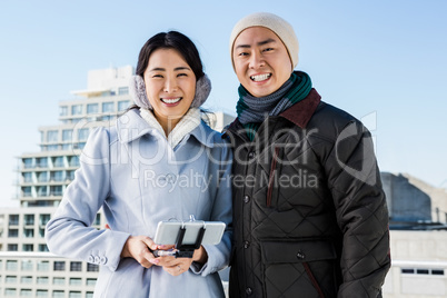 Cheerful couple against buildings