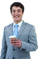 Smiling asian businessman drinking coffee