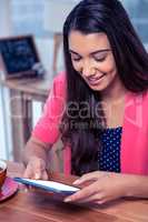 Happy businesswoman using digital tablet