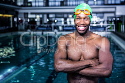 Fit swimmer standing with arms crossed