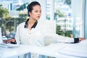 Smiling businesswoman typing on her computer