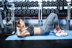 Concentrated fit woman doing sit ups