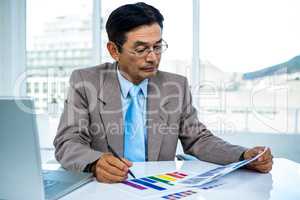 Businessman looking at graphics