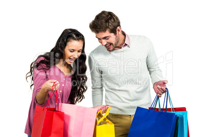 Excited couple with shopping bags