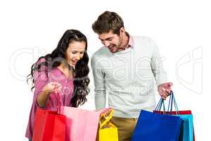 Excited couple with shopping bags