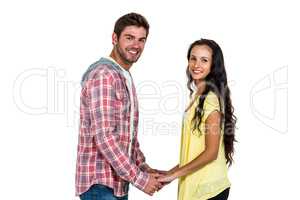 Smiling couple holding their hands and looking at camera