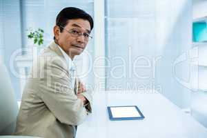 Serious businessman using tablet