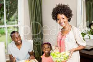 Smiling mother serving food