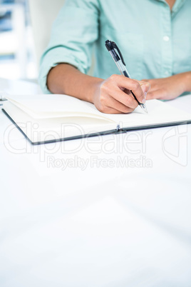 Close up view of a businesswoman writing notes