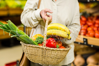 Senior woman holding wicker basket