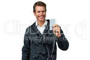 Portrait of happy man listening music on mobile phone