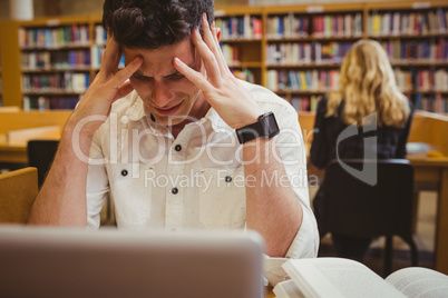 Stressful student holding his head