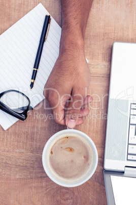 Cropped image of businessman having coffee