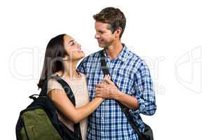 Cheerful couple with bags embracing each other