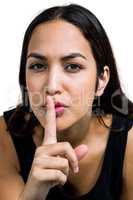 Young woman with finger on lips