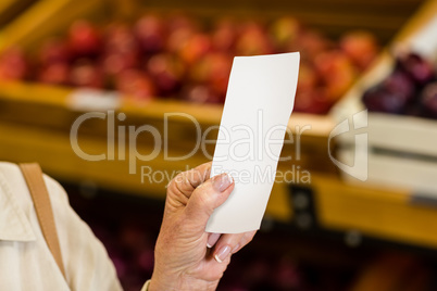 Female consumer holding a receipt