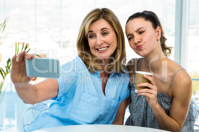 mother and daughter take selfie