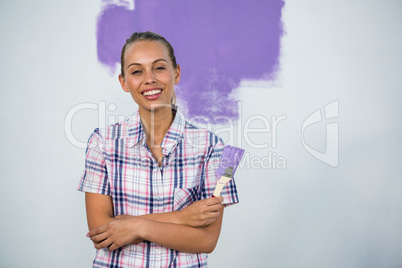 Smiling woman painting a wall