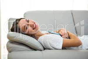 Happy woman laying on sofa