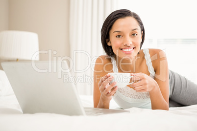 Smiling brunette holding cup