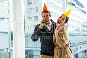 Cheerful couple celebrating birthday against glass window