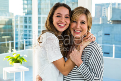 Happy mother and daughter hugging each other