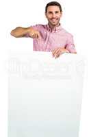 Attractive man holding and pointing white sheet