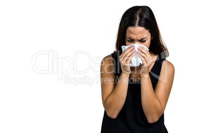 Unhappy woman blowing nose